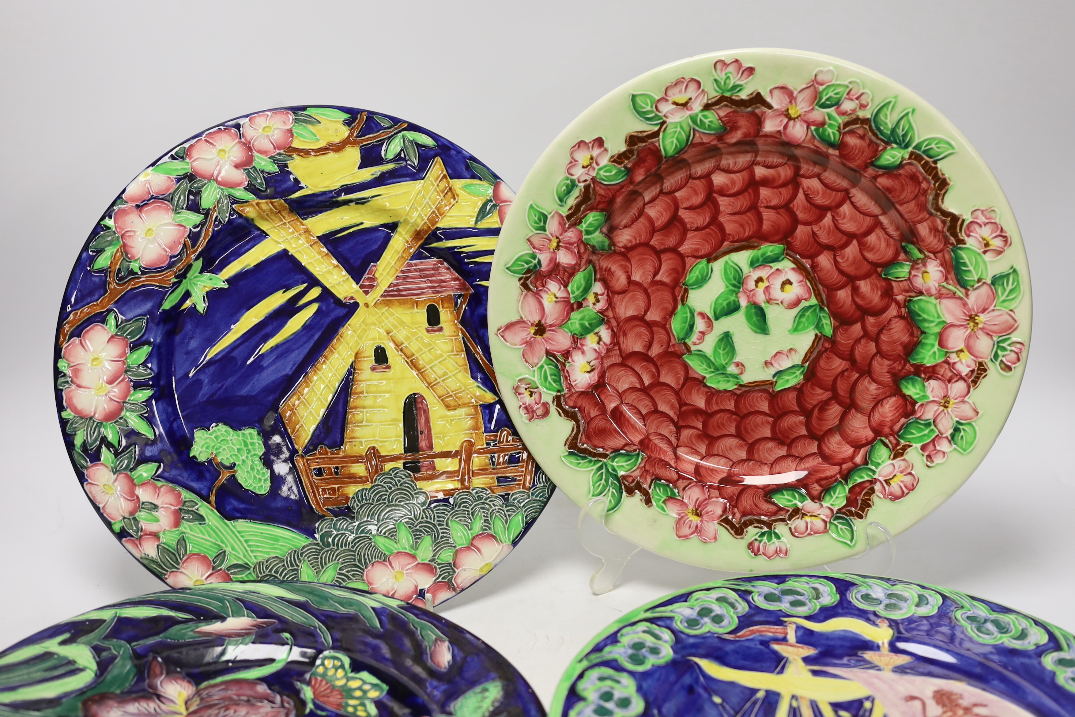 Set of nine Maling, Newcastle pottery plates, many with tube lined decoration including a galleon ship and Windmill, 29cm diameter